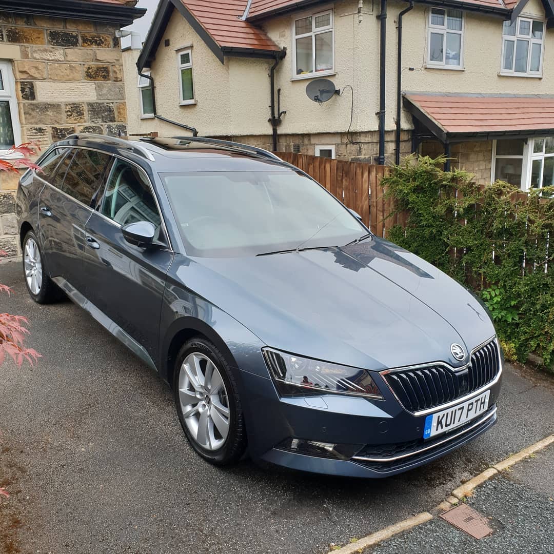 Grey estate car after cleaning on a driveway